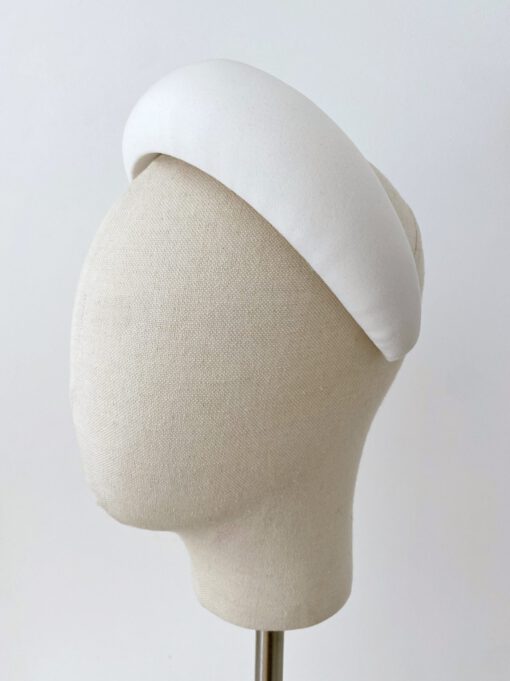 Diadema de crepe de alta calidad cosida a mano. Se sujeta mediante una peineta situada en la parte superior interior. Perfecta para novias elegantes.